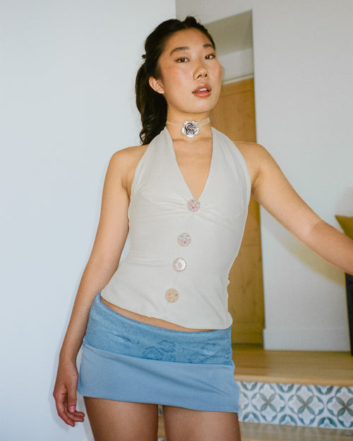 Woman wearing The Tresaire Classic Mini in dusty blue with lace waistband overlay
