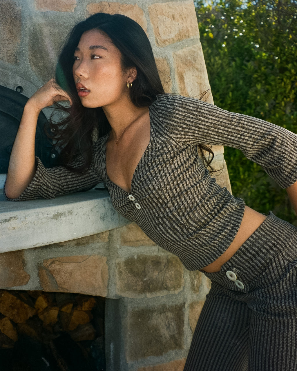 Woman wearing The Tresaire 3/4 Sleeve in striped rib with mother of pearl button cuffs
