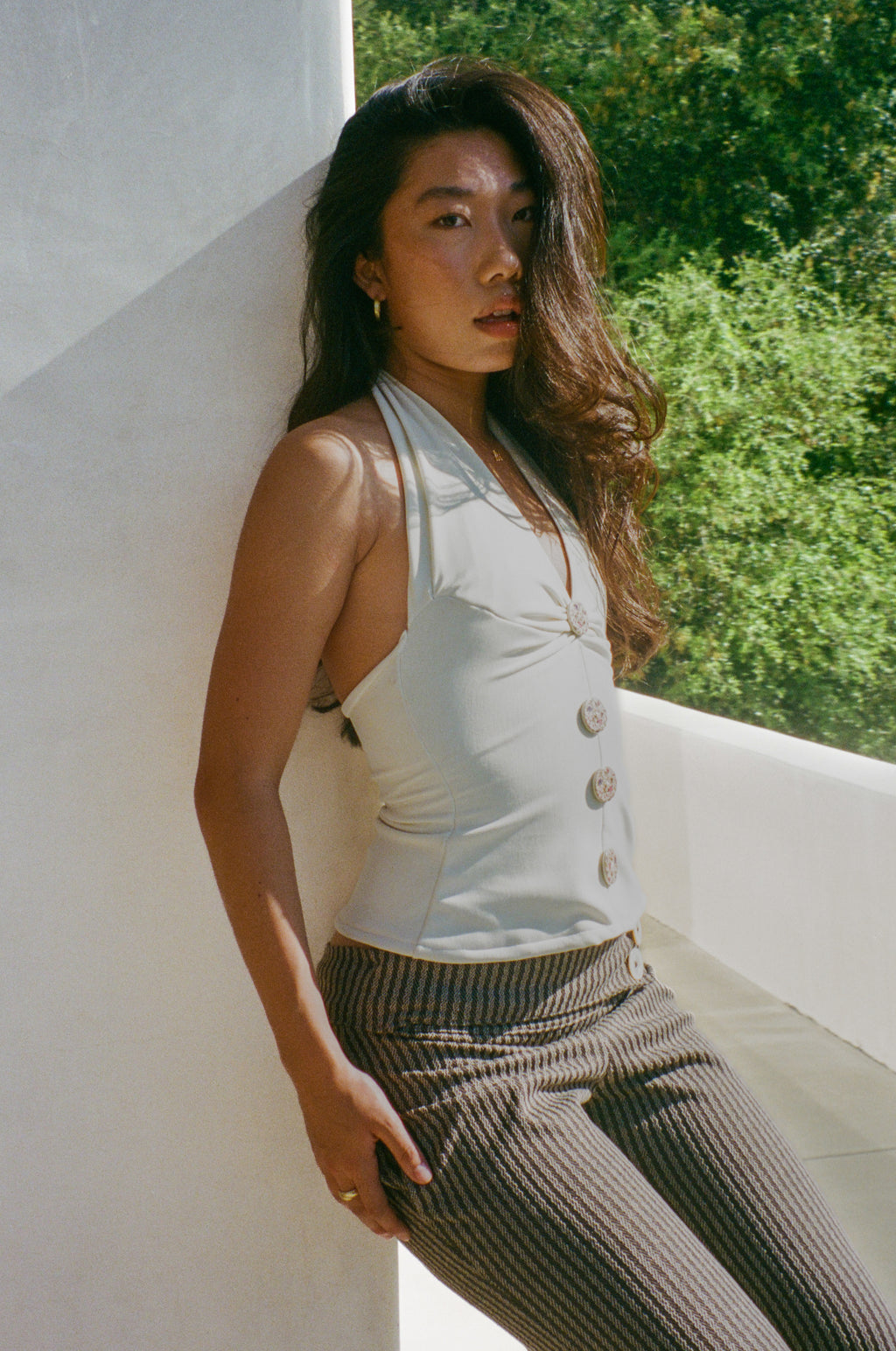 Close up of handcrafted floral buttons on The Tresaire Halter ivory top
